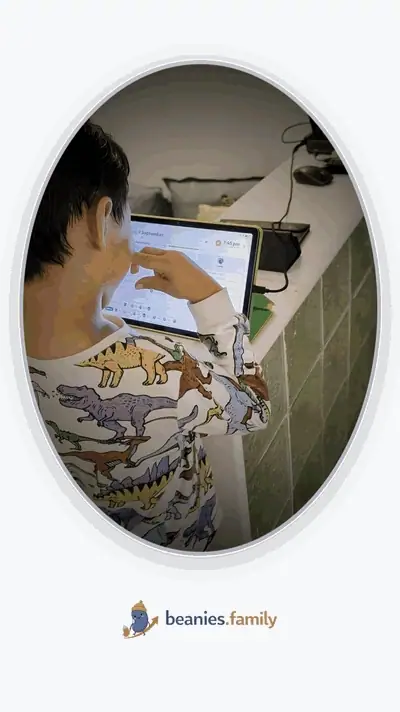 A young boy grinning and hamming it up for the camera beside the tablet running the beanie wall