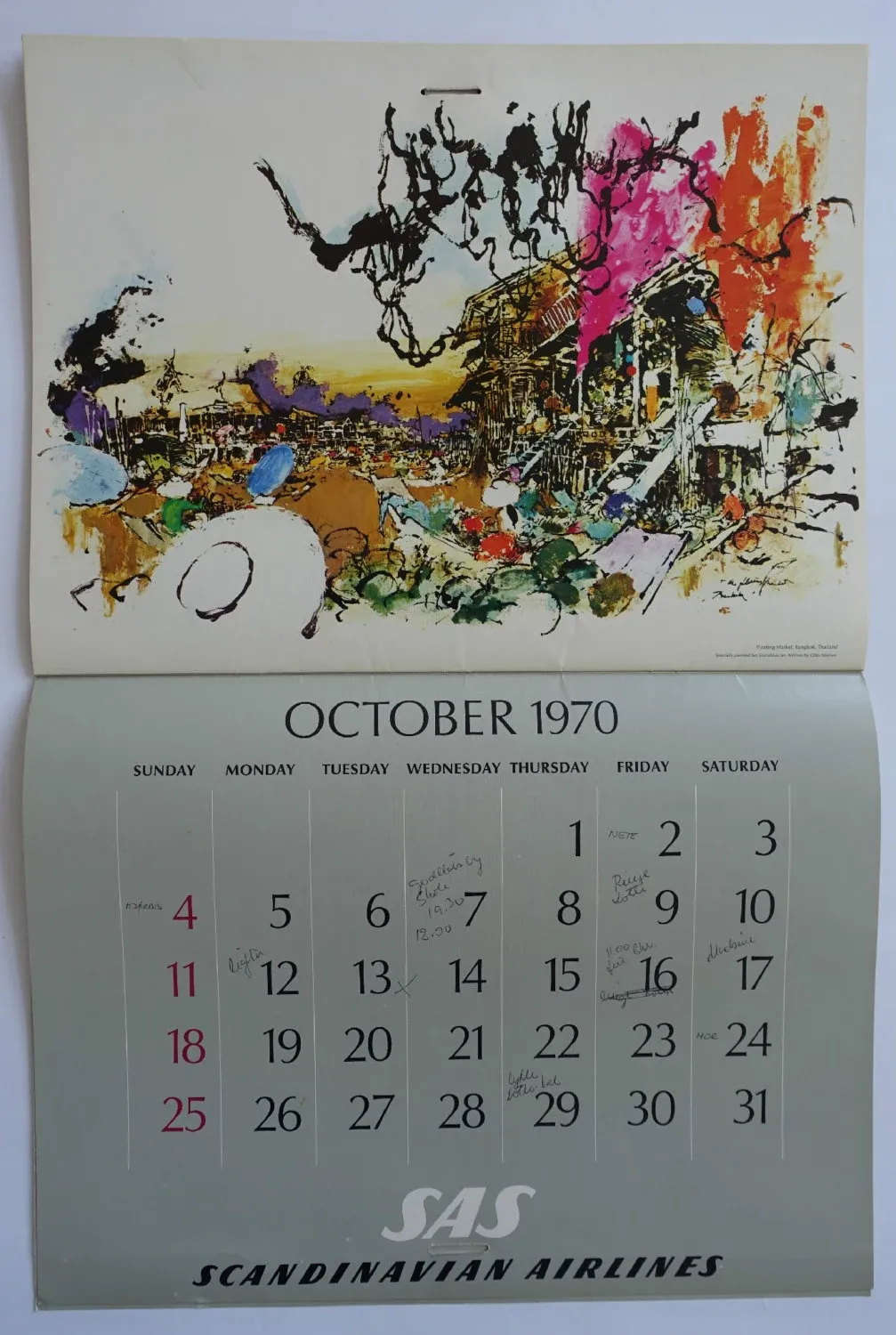 A vintage SAS Scandinavian Airlines wall calendar opened to October 1970, an abstract painting of a Bangkok floating market above the month grid, with a few days annotated by hand