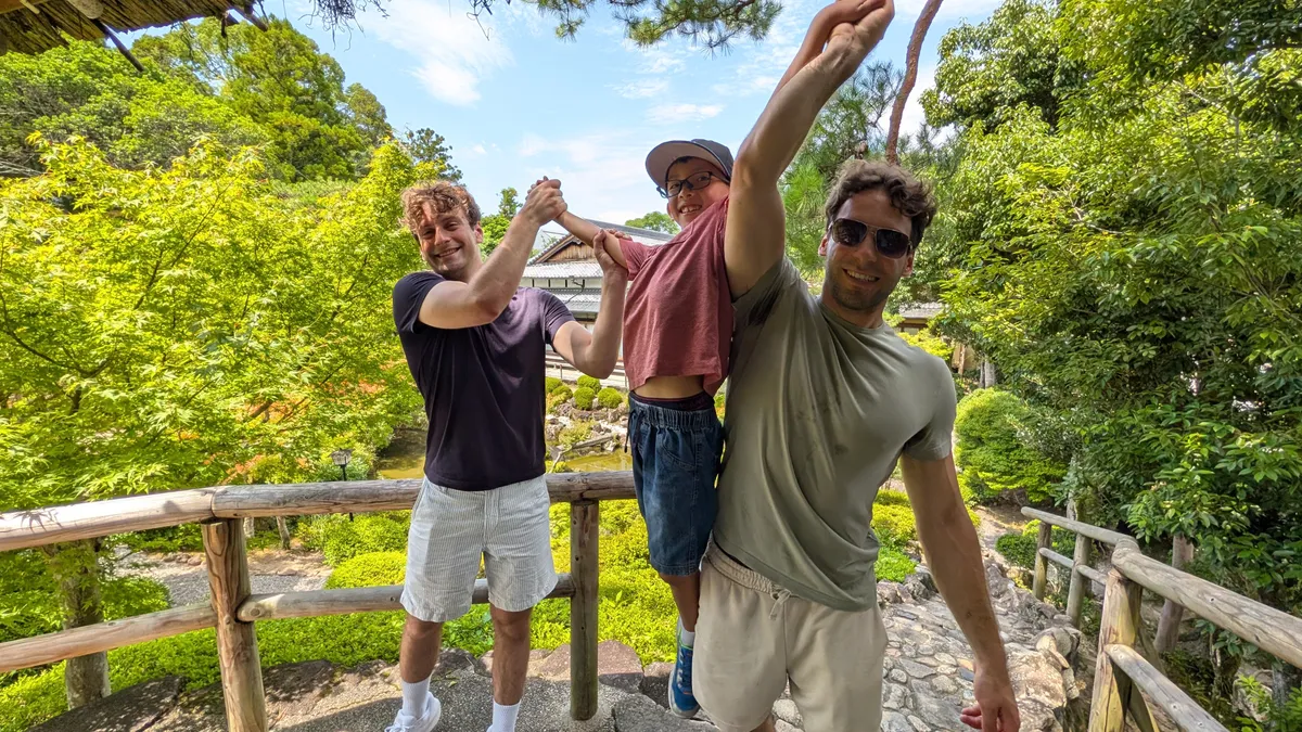 greg's seven-year-old son riding on an older cousin's back during a day of touring in Osaka