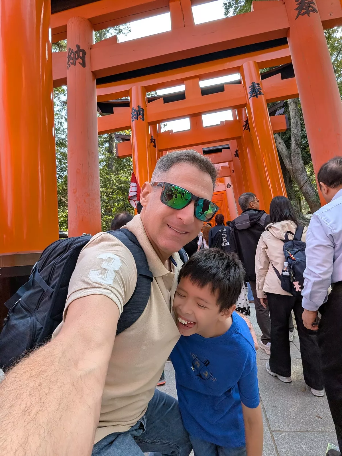 greg and his son neil under the torii gates at fushimi inari taisha in kyoto